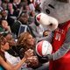 The Houston Rockets mascot Clutch asks for a basketball to be autographed by Destiny's Child members Michelle Williams, Kelly Rowland, and Beyonce Knowles before the NBA All-Star game in Houston, Texas February 19 2006.